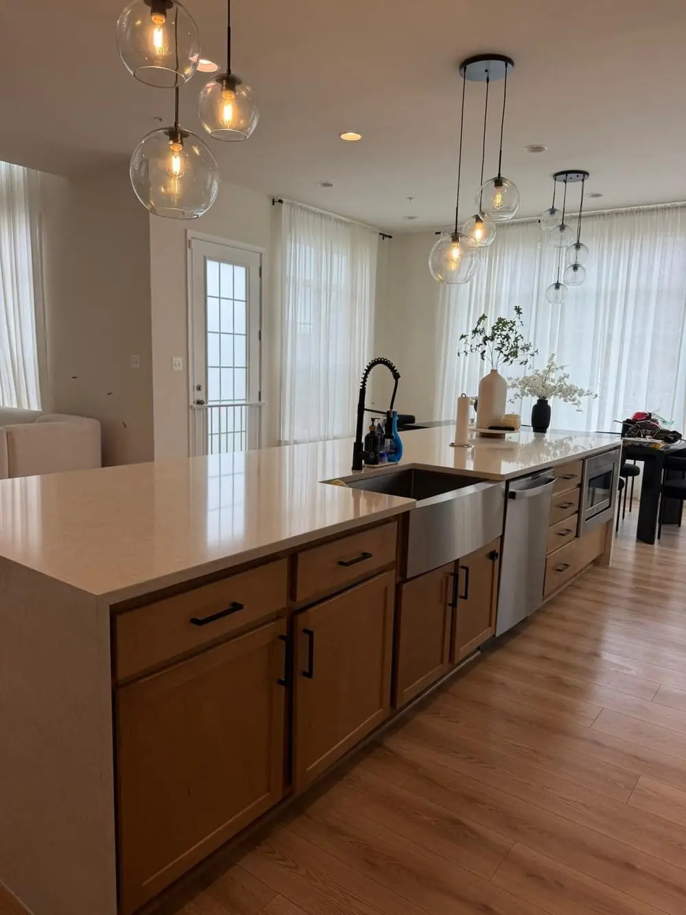 Kitchen island cleaned and ready, with pendant lighting