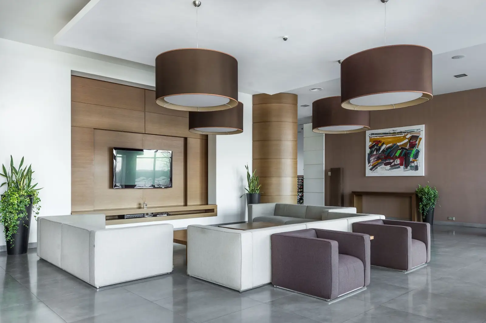 Reception lounge with sofas and pendant lights